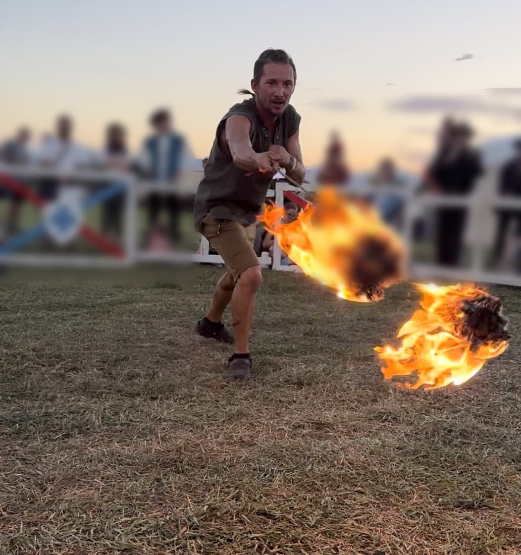 Tyler spinning fire rope darts at the Utah Renaissance Faire at sunset