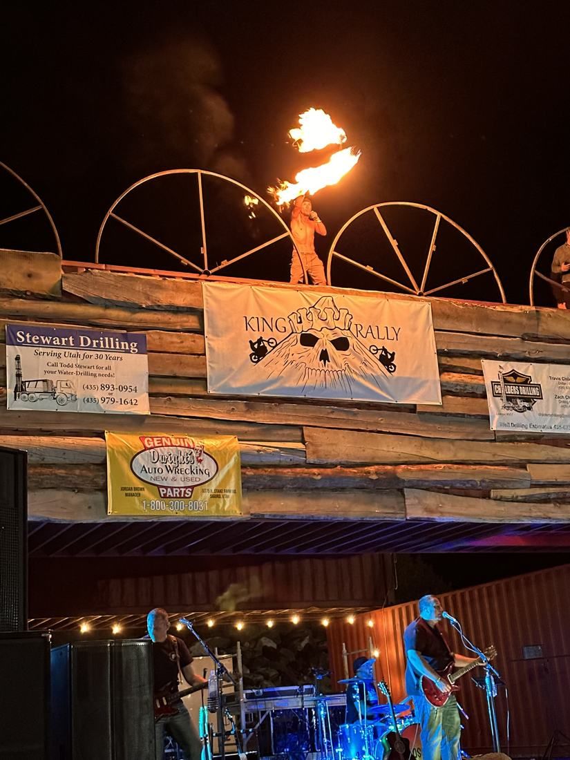Tyler spinning fire on a rooftop above the band at King Biker Rally
